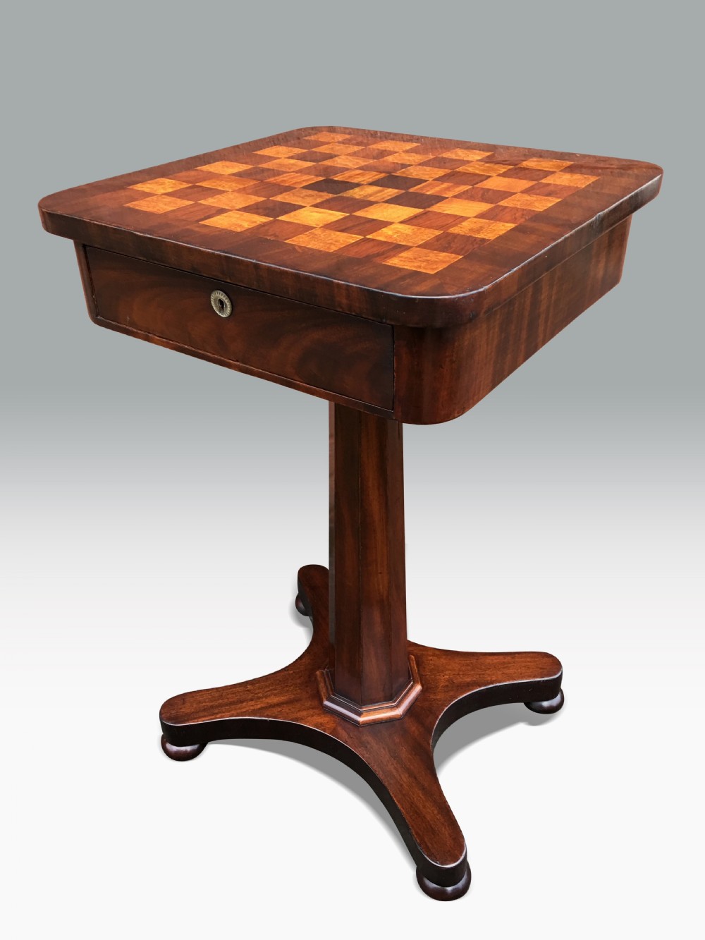 an early victorian mahogany games table